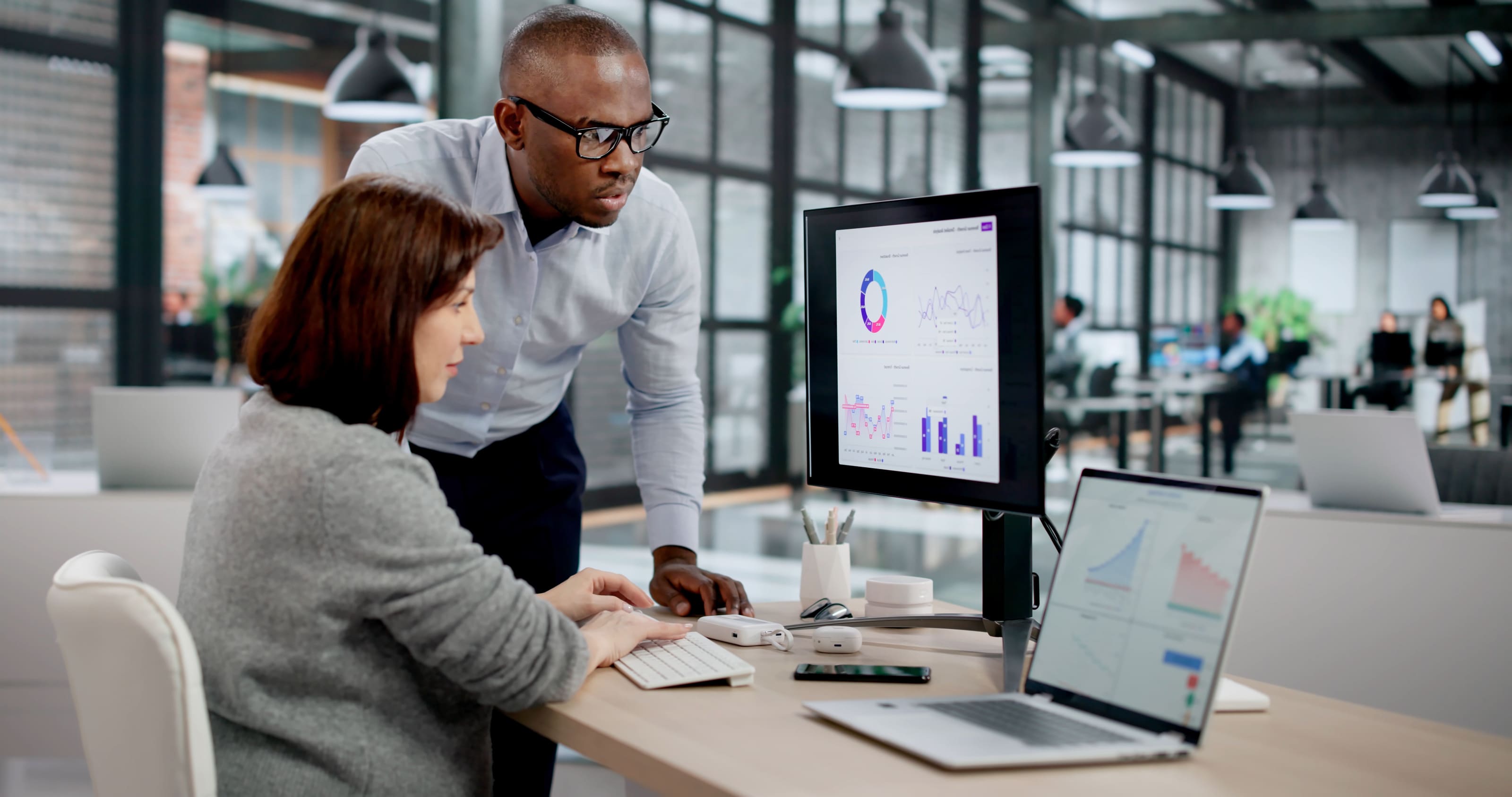 SkillSaige onboarding training experience. A man and woman at a computer.
