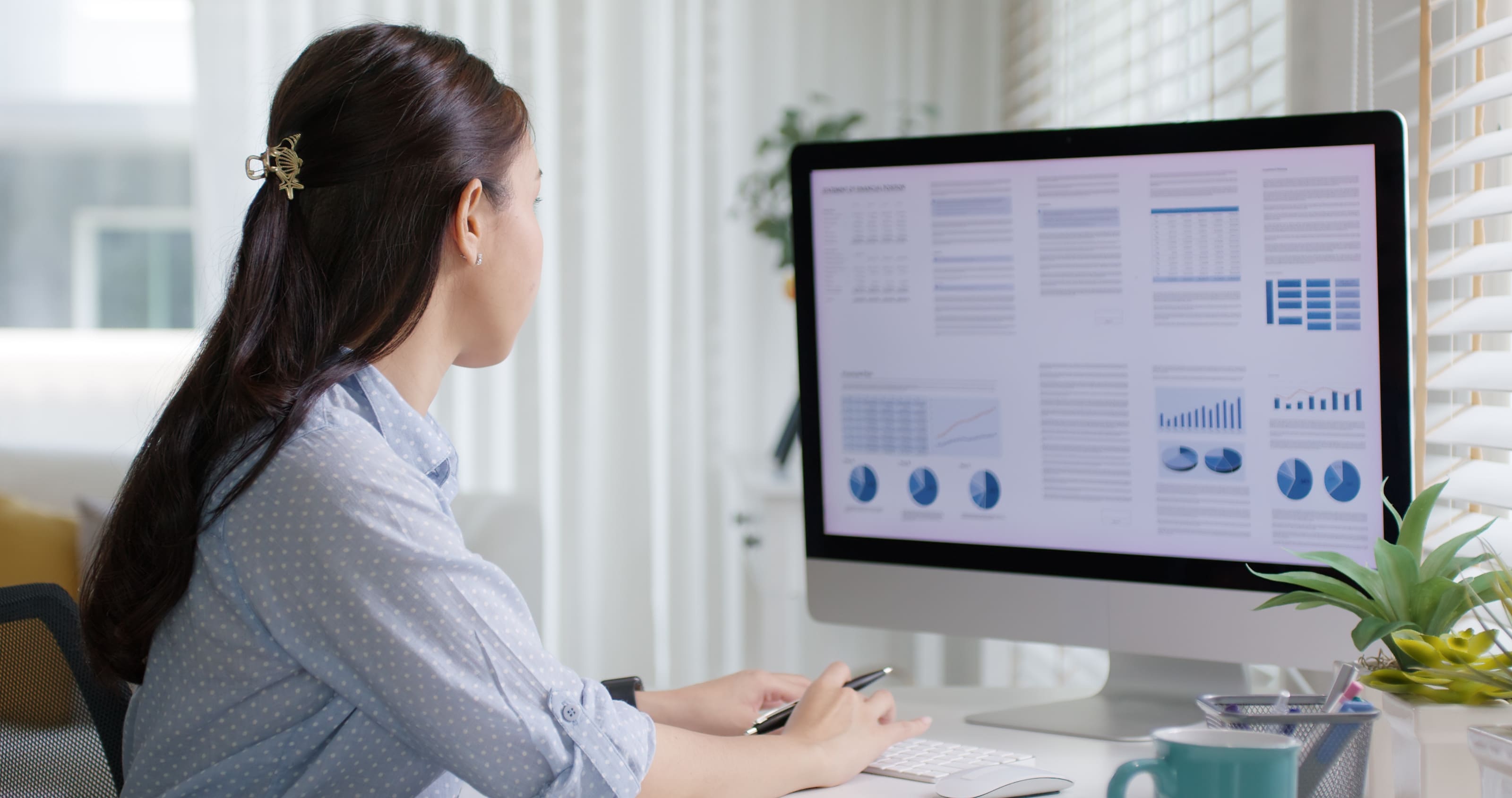 SkillSaige manage feature woman looking at data on a computer screen